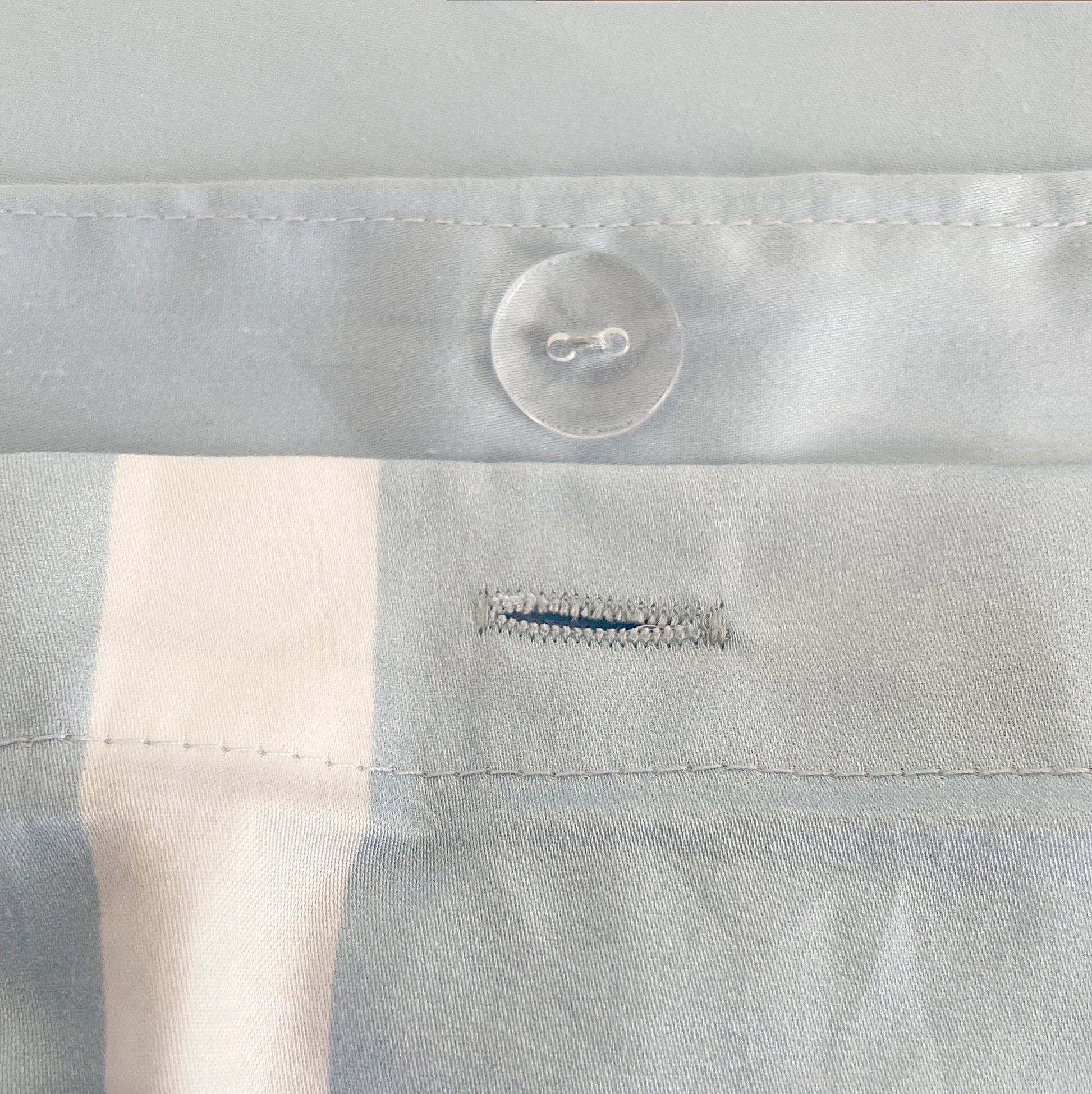 Soft and durable 100% cotton winter-weight bed sheets in classic navy and white stripes, featuring a convenient button closure design for secure fit and long-lasting use.