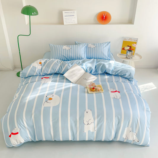A bright and cozy bedroom featuring a light blue and white striped bedding set with adorable polar bear illustrations. The bed is neatly arranged with matching pillows, an open book, and a small tray of desserts, creating a relaxing and inviting atmosphere.