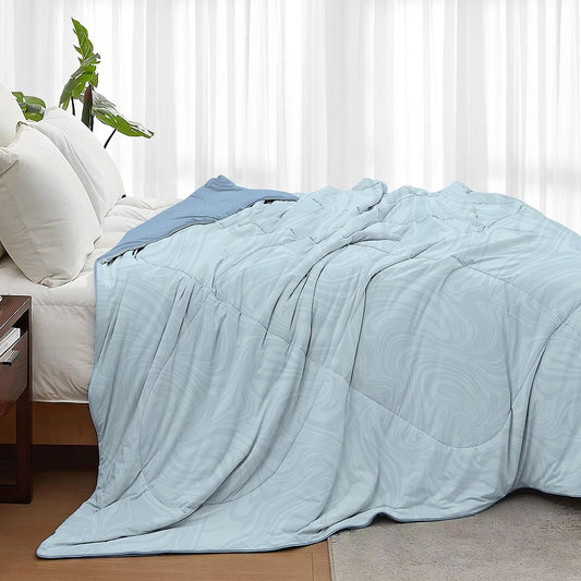 Cool blue Tencel quilt, offering a soft, breathable texture for a comfortable and refreshing sleep experience.