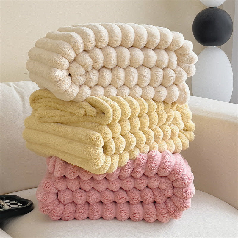 Soft and cozy winter blanket available in white, butter, and pink shades, perfect for adding warmth and elegance to chilly nights.