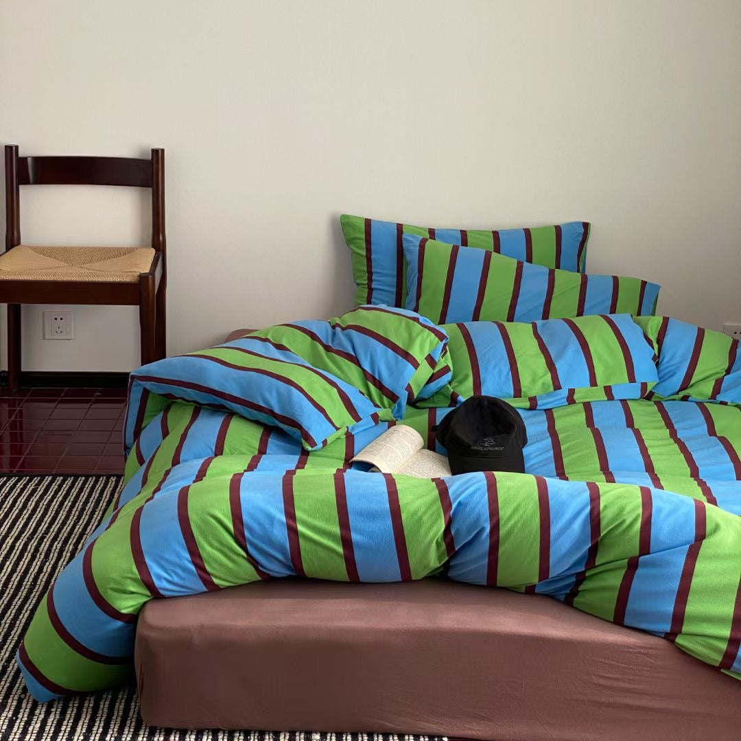 Green striped bed sheets made from soft cotton, offering a fresh and cozy look for your bedroom.